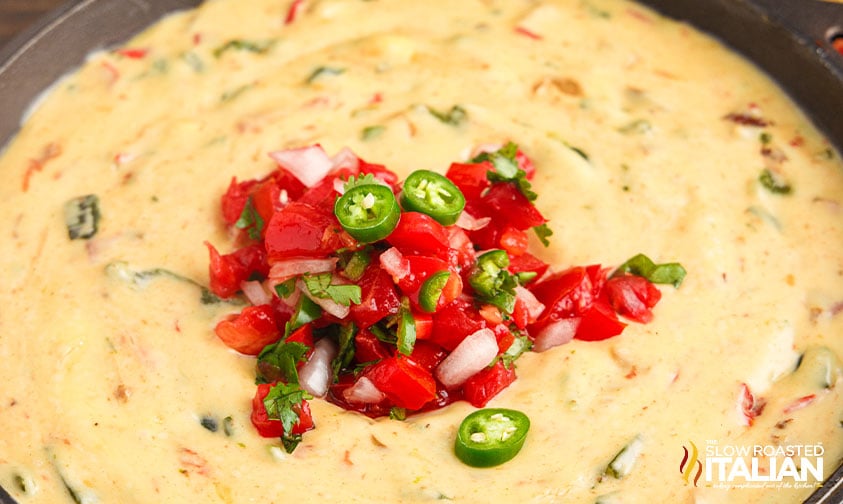 close up of chipotle queso with toppings