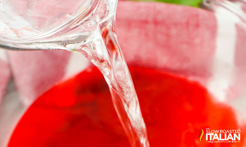 pouring vodka into jello mix