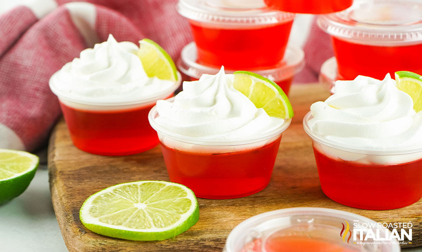 dirty shirley jello shots on wood board with lime slice