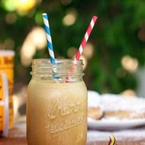 frozen coffee drink in mason jar glass with 2 straws