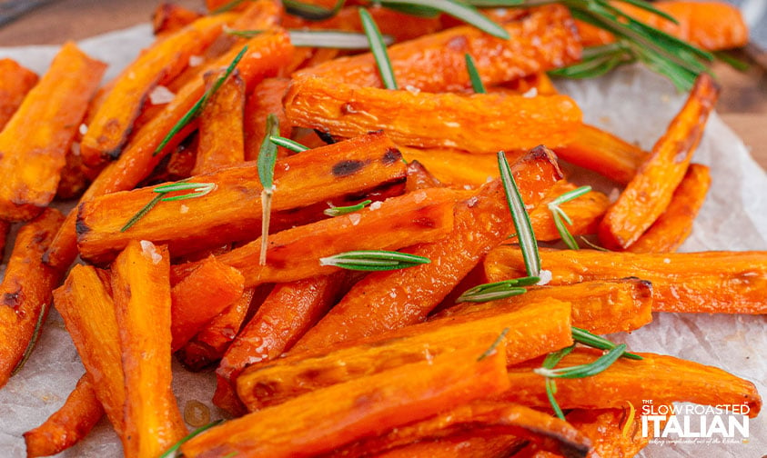 pile of air fryer carrots with rosemary on parchment paper