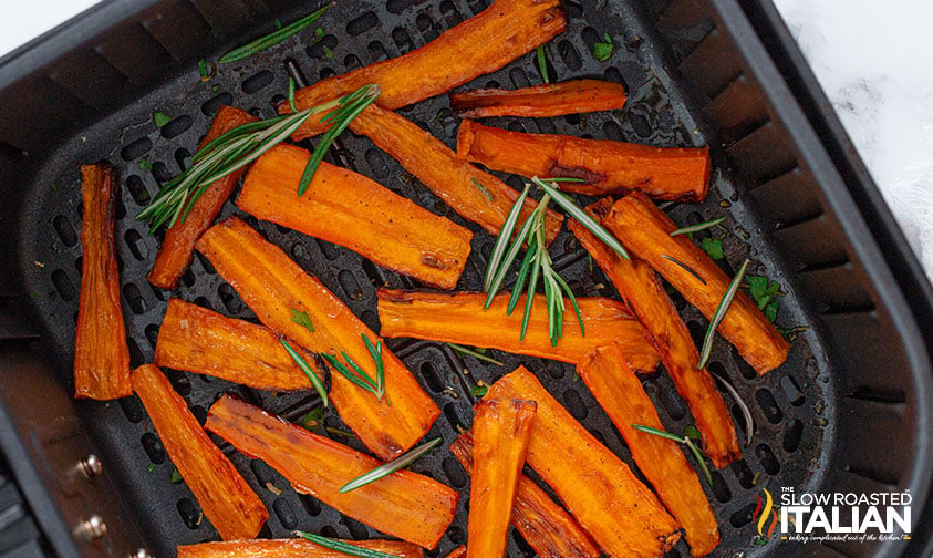 carrots and rosemary in air fryer basket