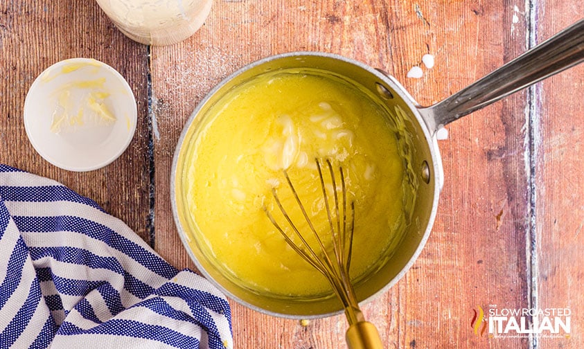 whisking italian cream pastry in sauce pan