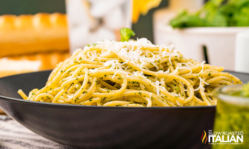 side view of pesto pasta recipe in a black bowl