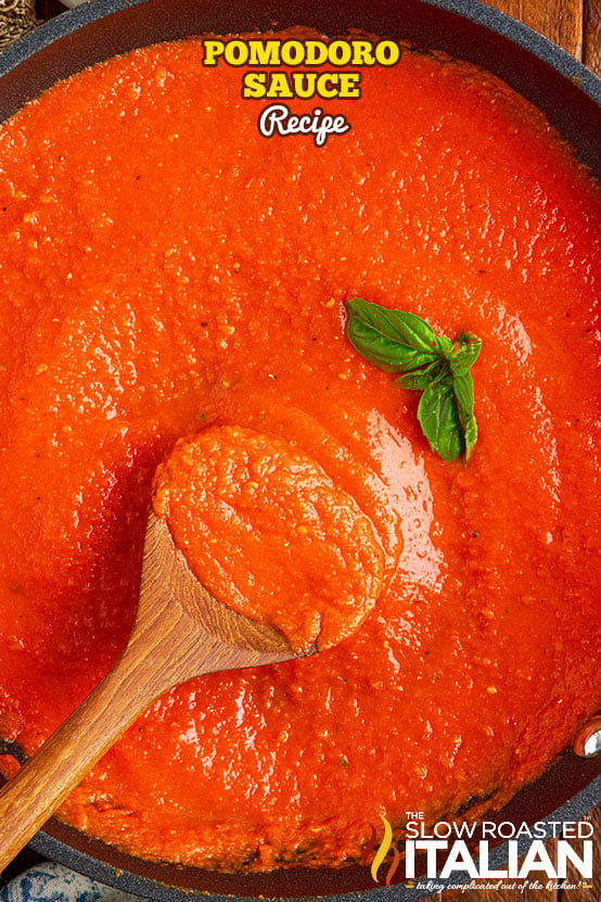 pomodoro sauce in pan with wooden spoon