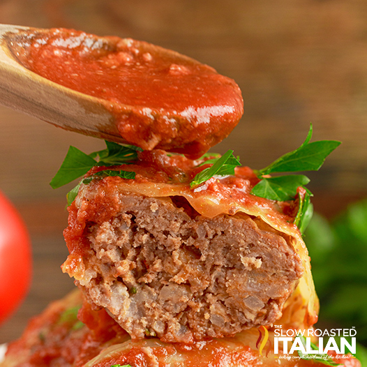 slow cooker cabbage roll cut in half with sauce