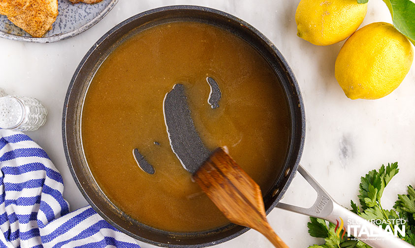 stirring brown sauce in pan.