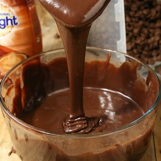 drizzling chocolate ganache in a bowl
