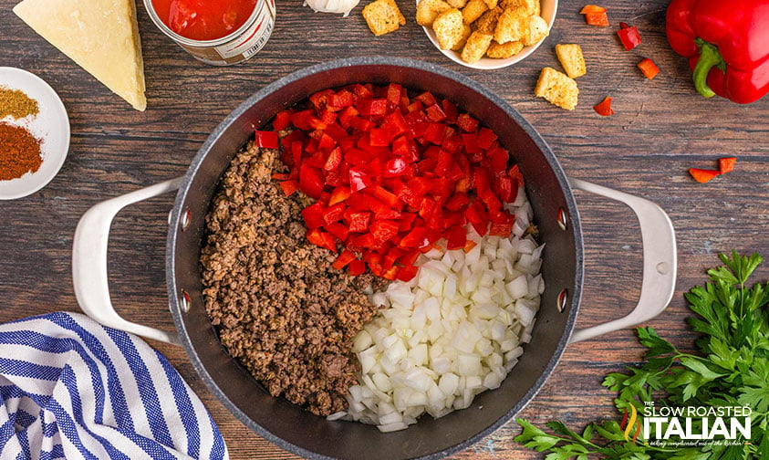 adding peppers and onions to browned meat