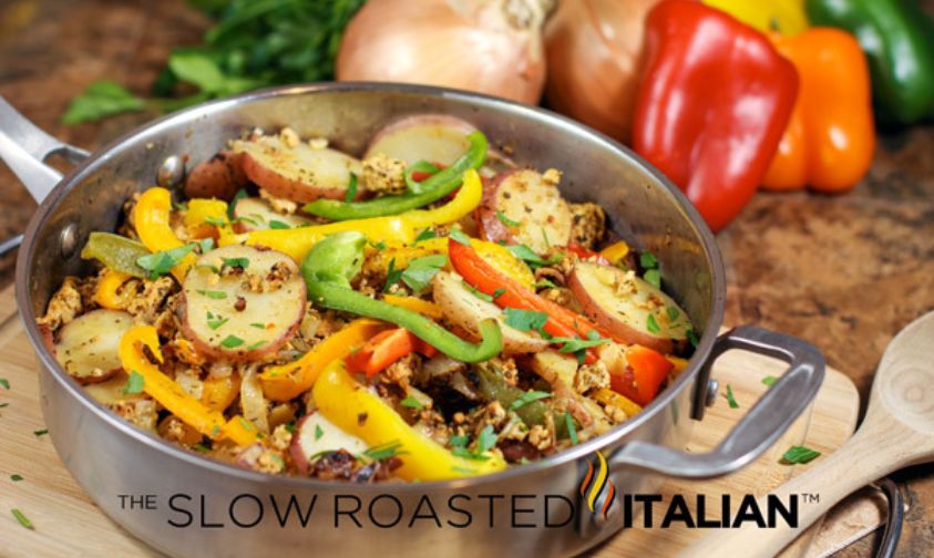 sausage, pepper and potatoes in a large skillet, on a cutting board