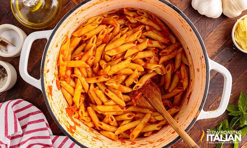 penne added to sauce in large pot