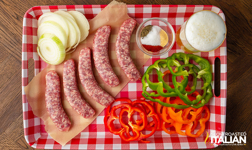 smoked bratwurst ingredients on gingham checked plastic tray.