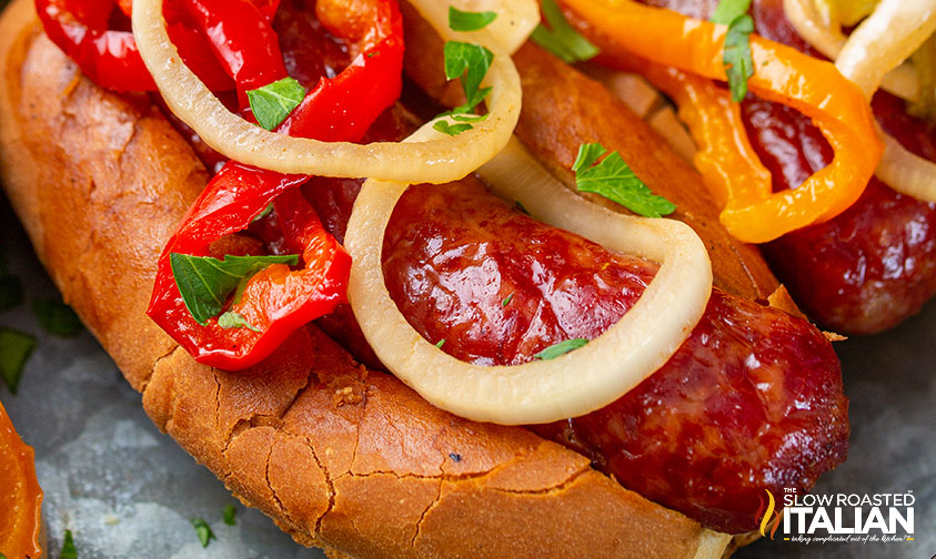 smoked brats topped with smoked onions and bell peppers.