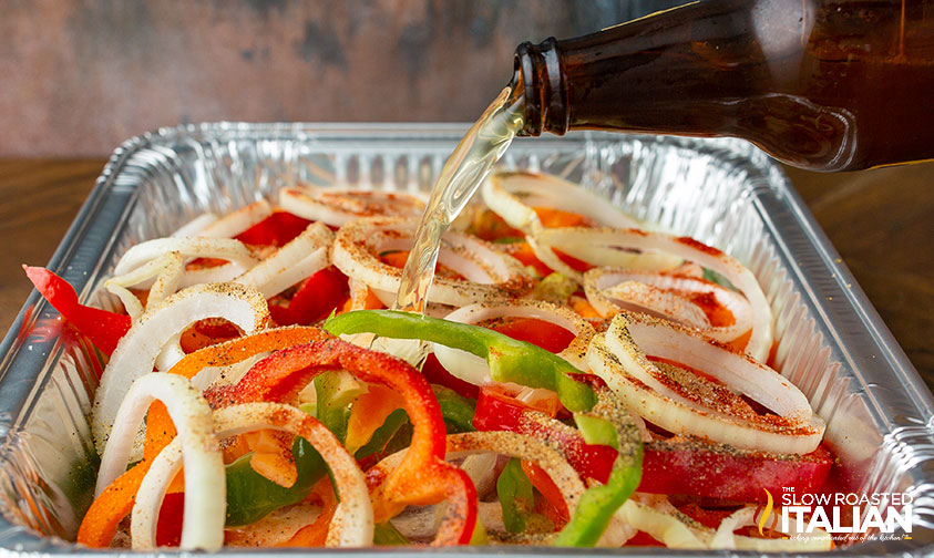 poring beer into pan of smoked brats.