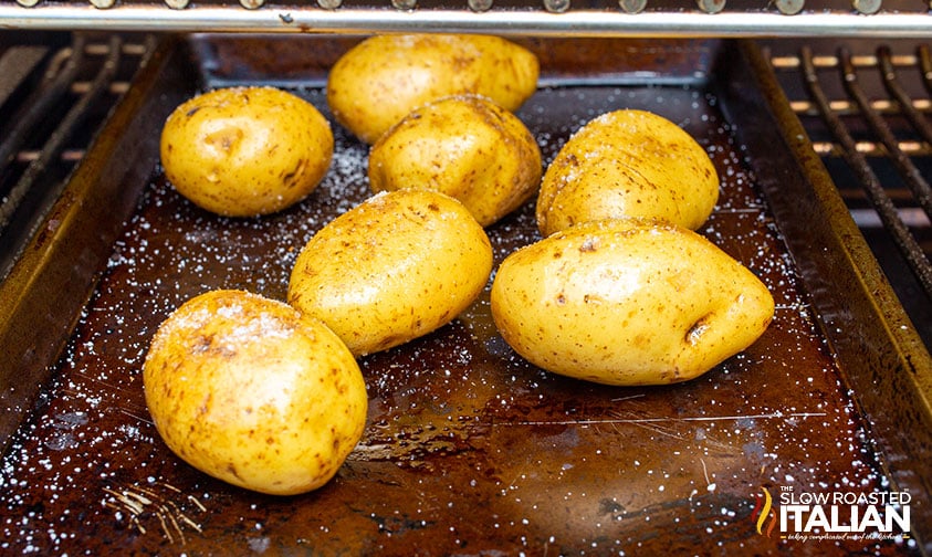 potatoes on baking sheet in smoker