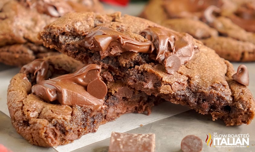 triple chocolate cookie sliced in half on baking sheet