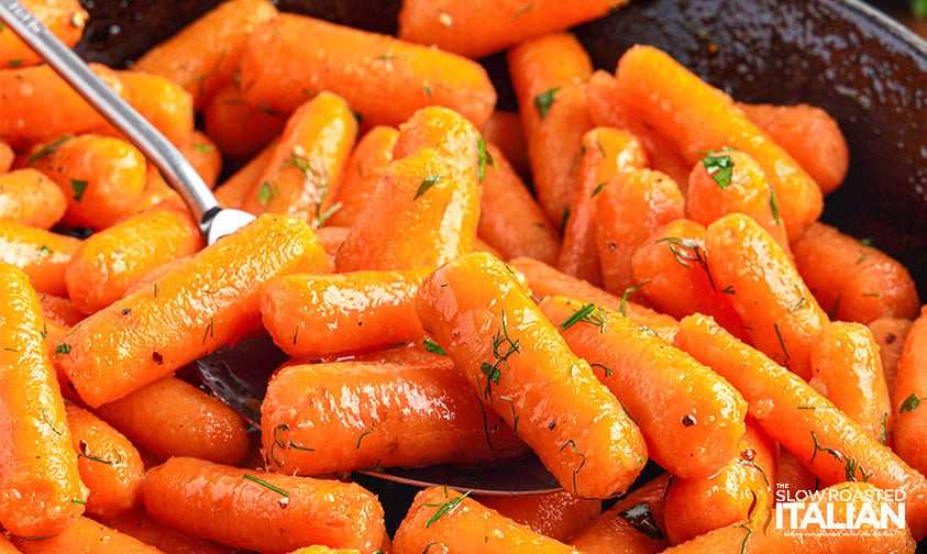 glazed baby carrots in pan.