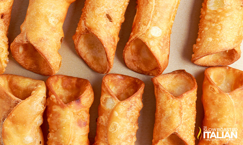 cannoli tubes on parchment paper.