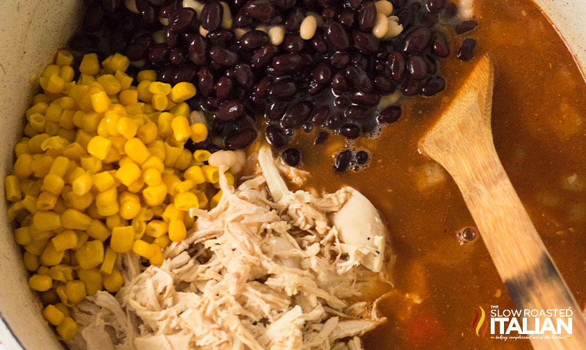 corn, beans, and chicken in a pot of soup