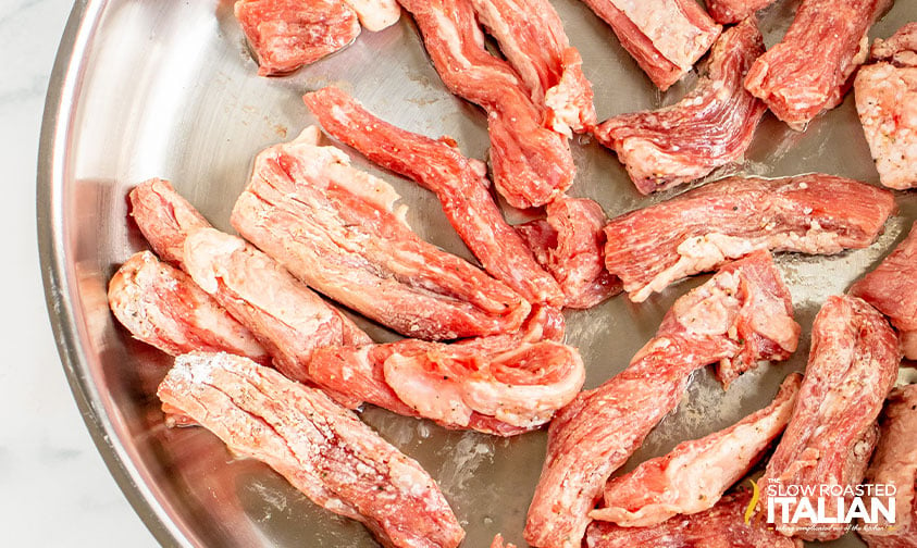 stir fried beef in skillet.