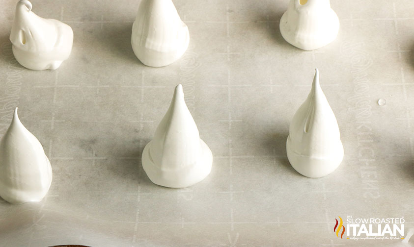 piped meringue cookies on parchment