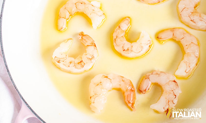shrimp in pan of olive oil.