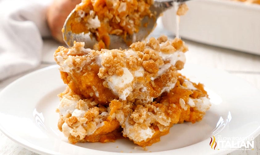 scoop of sweet potato casserole on white plate.