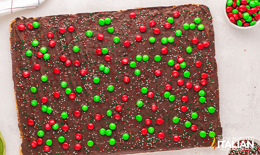 red and green m&ms on cracker toffee.