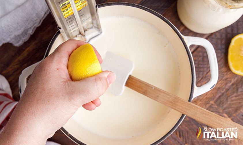 squeezing lemon juice into heavy cream.