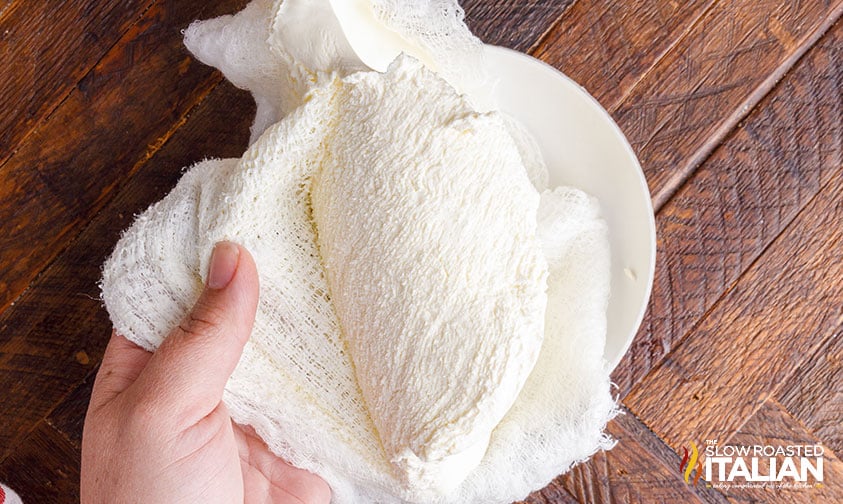 removing mascarpone from cheesecloth.