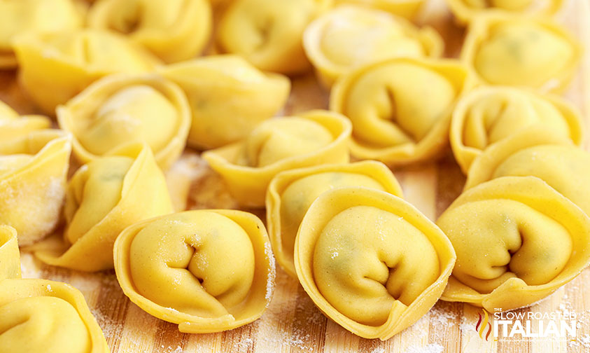 fresh tortellini on cutting board.