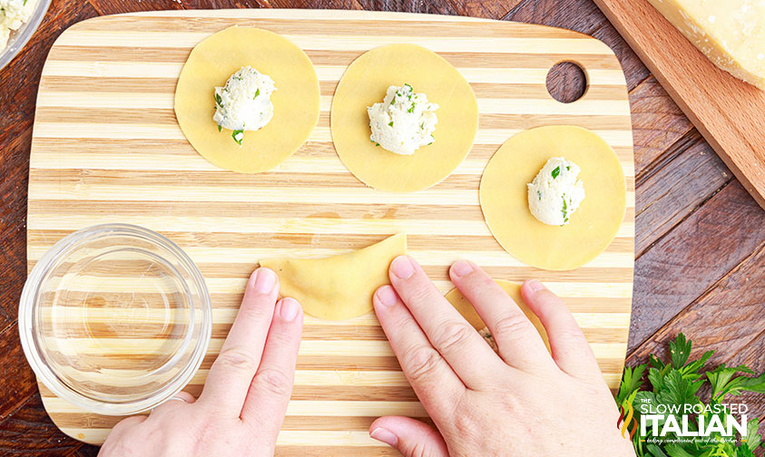 folding homemade tortellini.