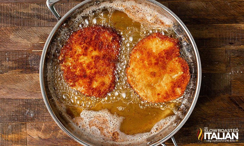 fried pork chops in skillet.