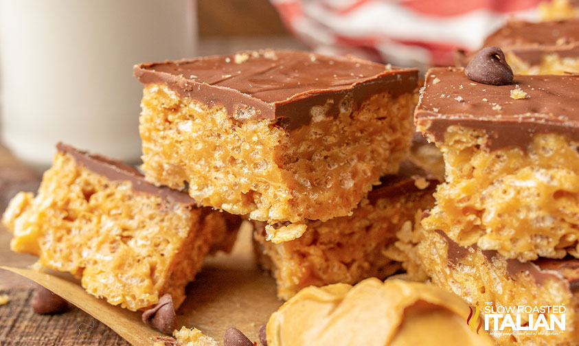 scotcheroo bars stacked on parchment paper.