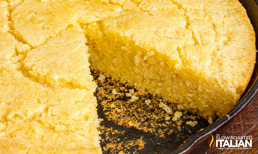 sweet skillet cornbread with piece missing.