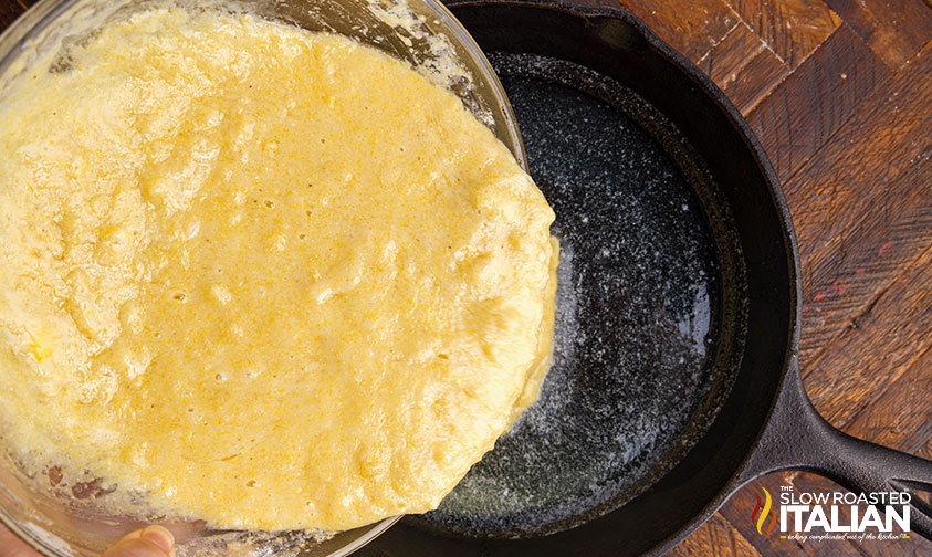 pouring cornbread recipe into cast iron skillet.