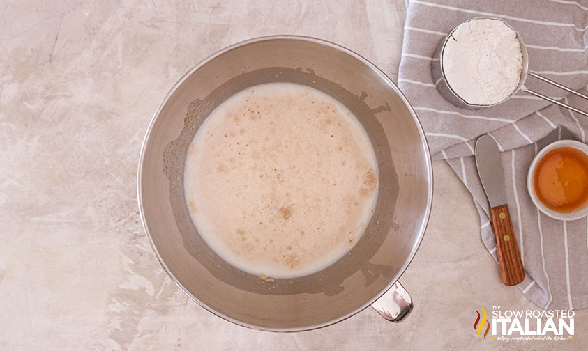 yeast and milk in stand mixer bowl.