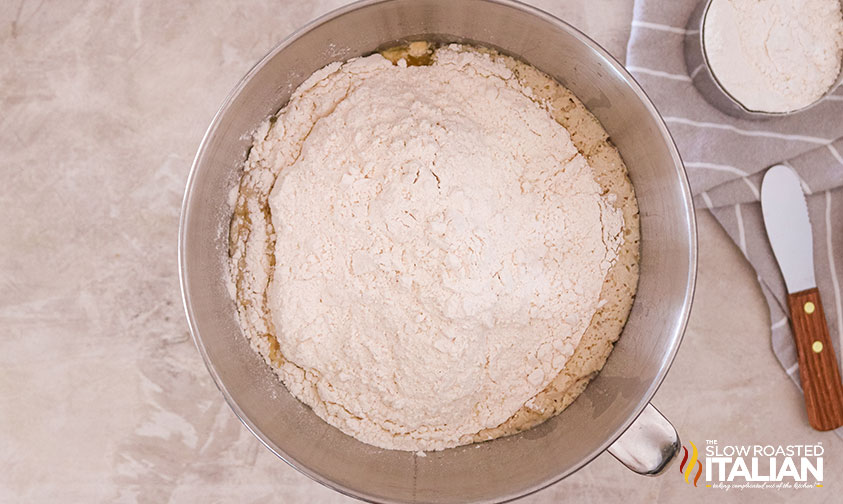 adding flour to stand mixer bowl.