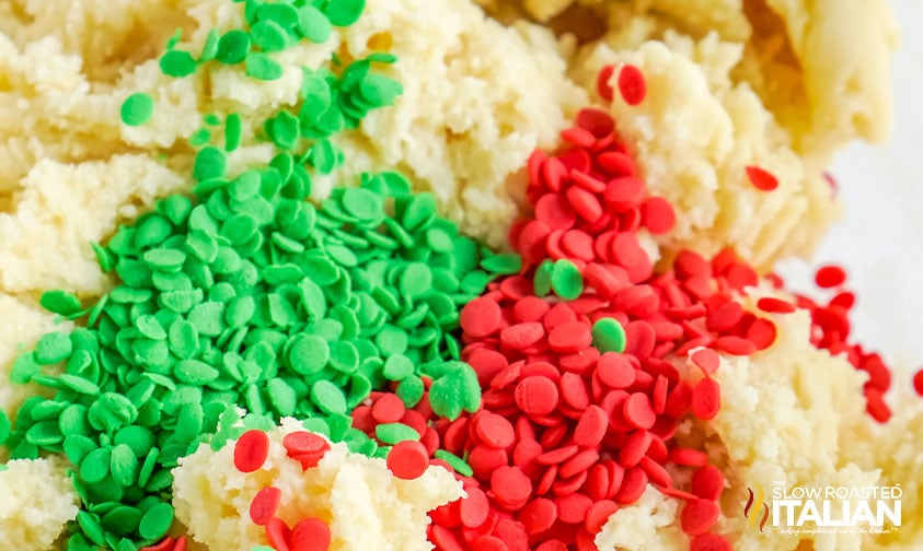 adding sprinkles to sugar cookie bar dough.