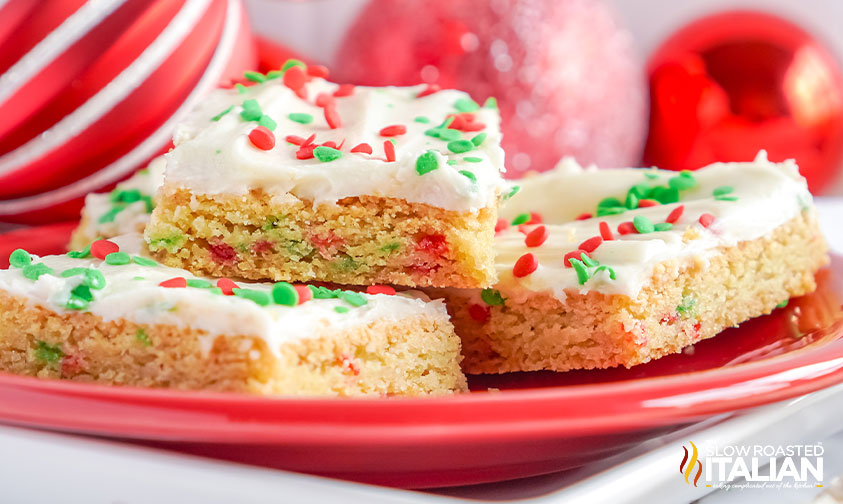 christmas sugar cookie bars on red plate.