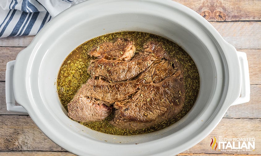 crockpot roast with spices and gravy.