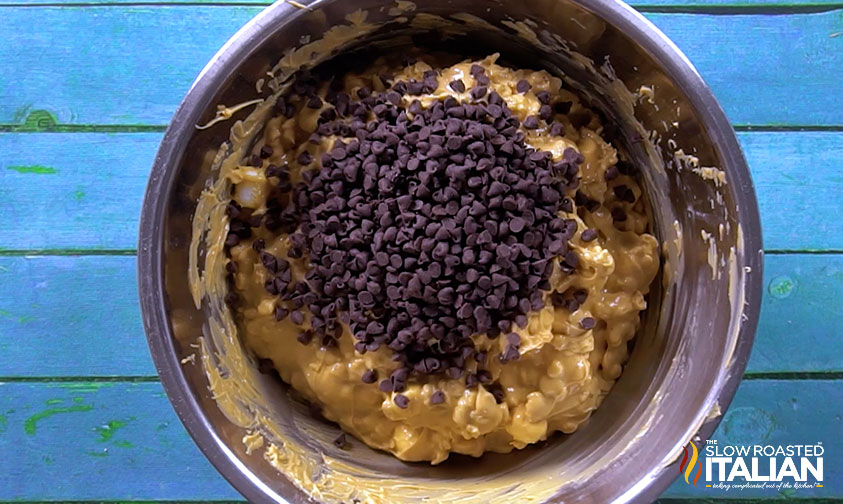 adding chocolate chips to bowl