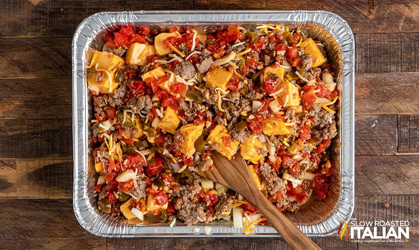 mixing smoked queso ingredients.