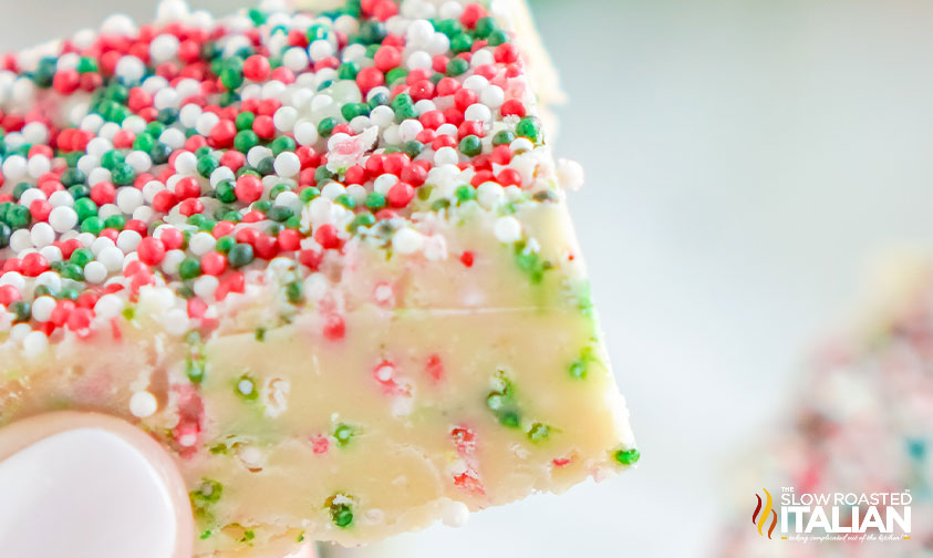 fingers holding square of fudge.