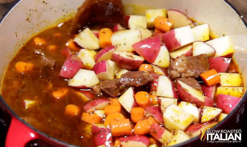 adding veggies to pot.