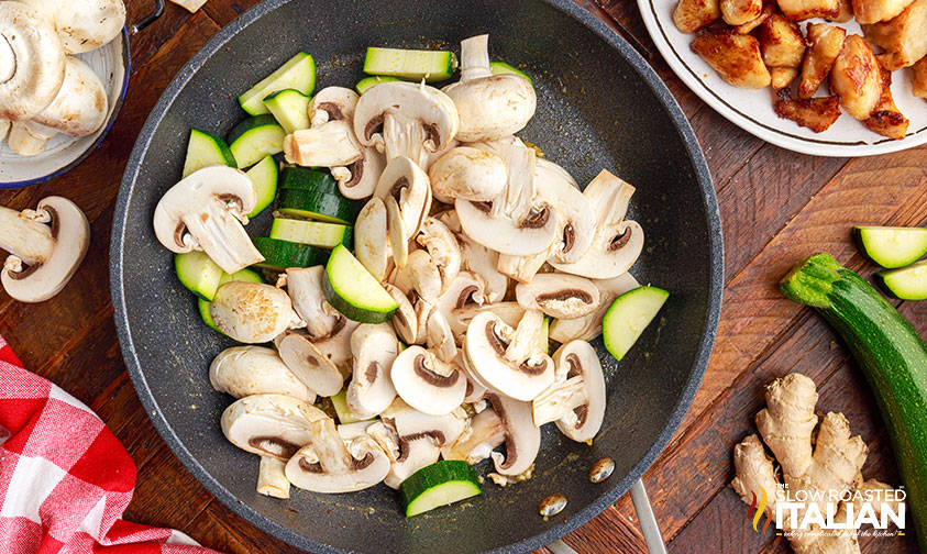 mushrooms and zucchini in pan.