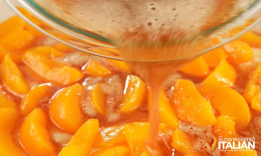 mixing peaches in bowl.