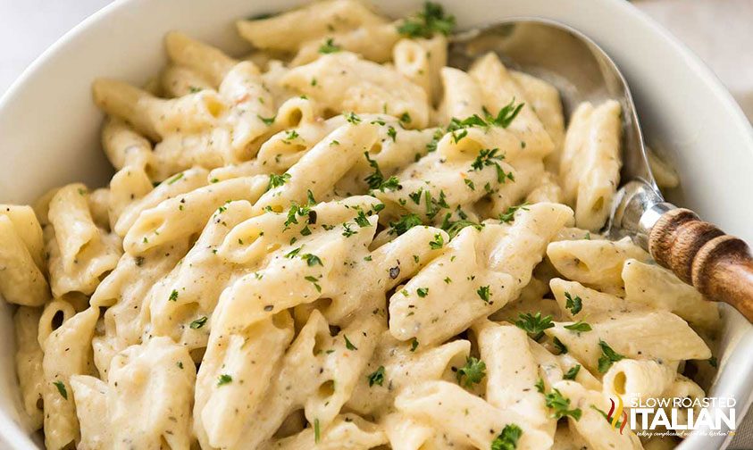 bowl of mozzarella mac and cheese topped with herbs