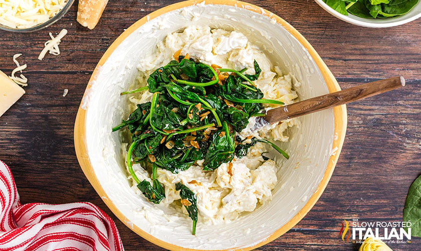 adding spinach to cheese dip