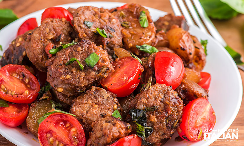 Italian sausage and potatoes on a white plate